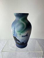 Full view of vase showing painted northern lights landscape