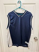 Full front view of Champion navy and white basketball jersey on hanger