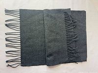 Scarf laid flat folded showing both fringed ends