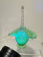 Front view glowing under UV showing hobnail body and clear handle