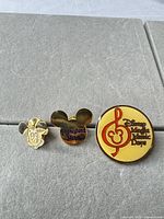 Front view of three Disney pins