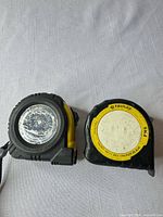 Front view of both tape measures showing faces, wear and branding