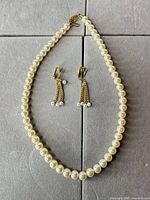 Full view of necklace strand and earrings set