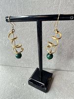 Front view of both earrings on stand