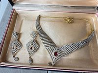 Necklace and both earrings in box showing full set
