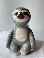 Front view of ceramic sloth coin bank
