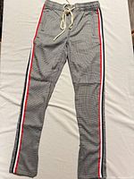 Full view of plaid jogger pants with side stripes and drawstring waist