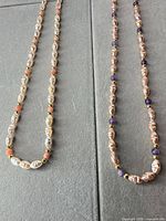 Both necklaces laid out full length showing bead styles and clasps