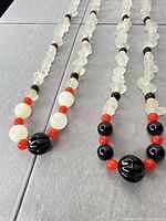 Both necklaces laid out showing overall design and colors