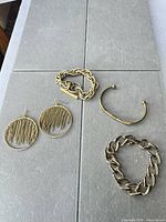 Group shot showing three bracelets and hoop earrings