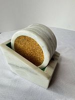 Marble holder with coasters stacked inside showing materials and design