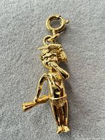 Front view of gold-tone Monet figural charm showing details and spring ring