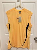 Front view of yellow Nike sleeveless athletic shirt with tag attached