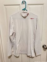 Front view of pullover on hanger showing Nike Swoosh and 49ers logo