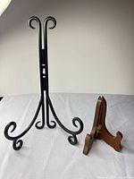 Black metal and wooden easels upright on table