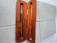 Pen inside open wooden case