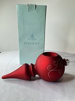 Full view of tree topper lying beside PartyLite box