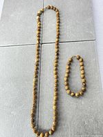 Necklace and bracelet laid flat showing bead pattern and size