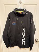 Front view of jacket on hanger showing full design and logos