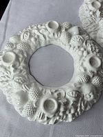 Top view of one wreath candle holder showing fruit relief and candle cups