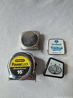 Overview of four tape measures on table