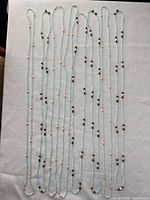 Full view of eight necklaces laid flat to confirm quantity, style and continuous loop design