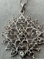 Front view of pendant showing design and rhinestones