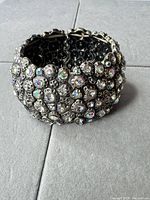 Front view of wide silver-tone rhinestone stretch bracelet