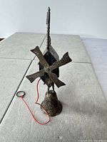 Full view of windmill chalet bell with red pull string
