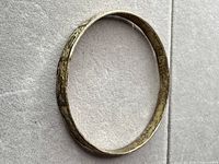 Full view of engraved gold-tone sterling silver bangle