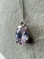 Close-up of the oval faceted amethyst pendant on sterling silver chain