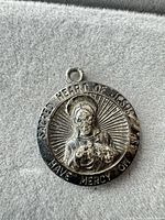 Front view of round sterling Sacred Heart pendant