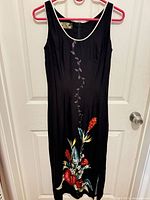 Full front view of black maxi dress showing floral print and overall length
