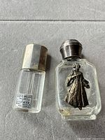 Two small glass perfume bottles showing overall condition