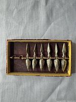 Boxed set of six metal corn cob holders