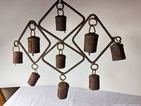 Front view of entire wind chime hanging, showing frame shape and all nine bells