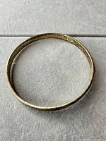 Overhead view of complete bangle showing hammered texture and patina
