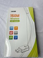 Front of sealed box showing 150M wireless USB adapter and antenna