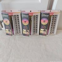 Front view of three sealed boxes of Kiss imPRESS Press-On Falsies