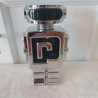 Front view of chrome robot bottle showing “P” emblem