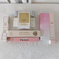 Group shot of eight fragrance items showing boxed and unboxed bottles