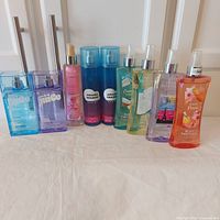 All nine body mists standing upright showing brands and colours