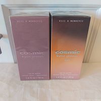 Front view of both sealed perfume boxes