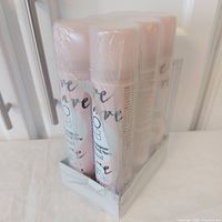 Front view of shrink-wrapped pack of six COLAB Dry Shampoo cans