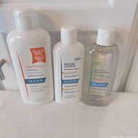 Three Ducray shampoo bottles front view