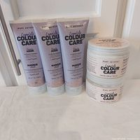 Three purple mask tubes and two nourishing mask jars grouped