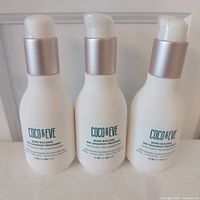 Three identical Coco & Eve Bond Building Pre-Shampoo Treatment bottles front view