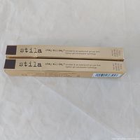Two boxed Stila Stay All Day eyeliners on white surface