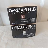 Two sealed Dermablend Professional Illuminating Banana Powder boxes front view