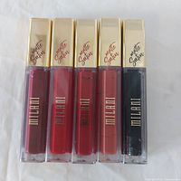 Five Milani Amore Satin Matte Lip Cream tubes front view